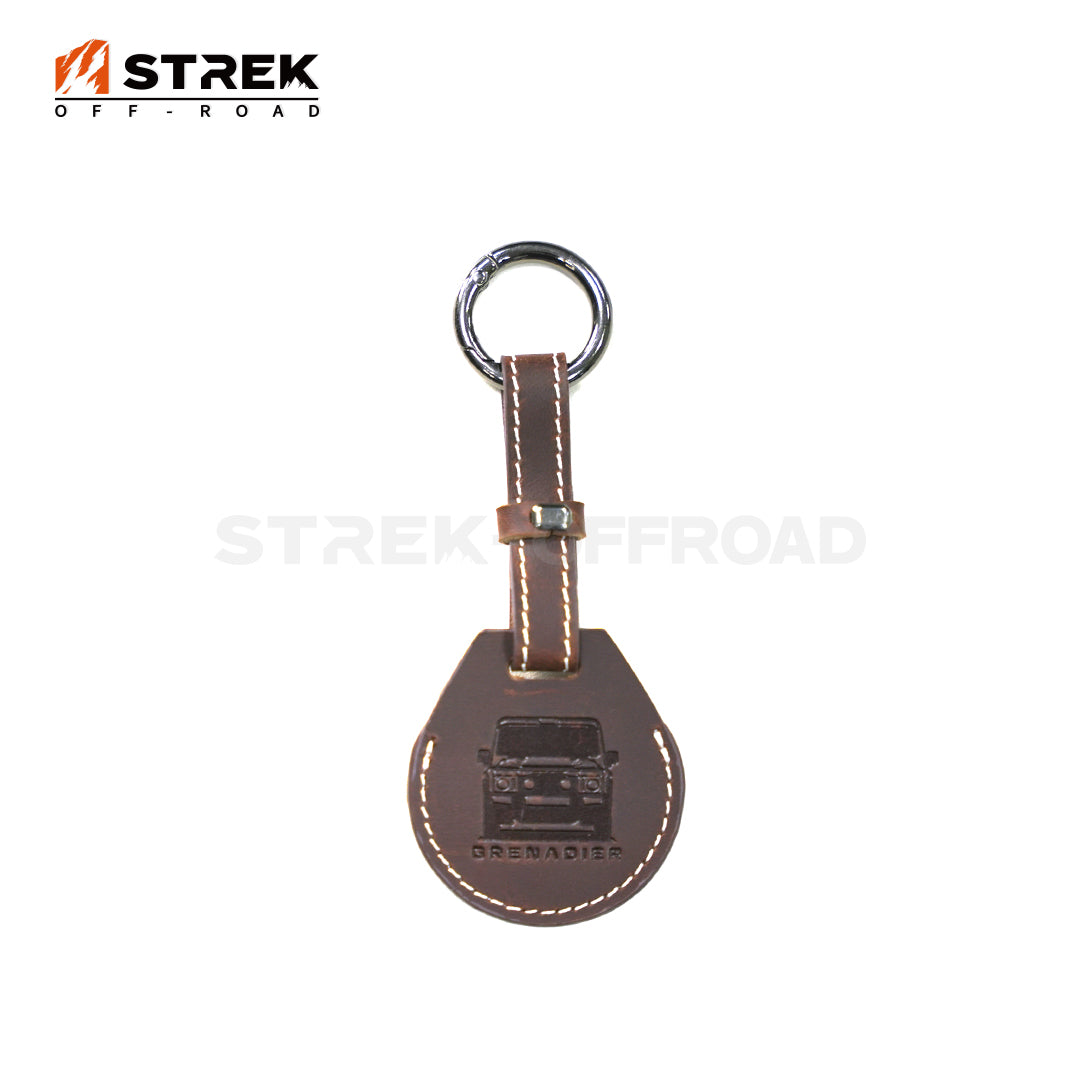 Brown leather keychain with metal ring and 'STREK OFF-ROAD' branding on a white background
