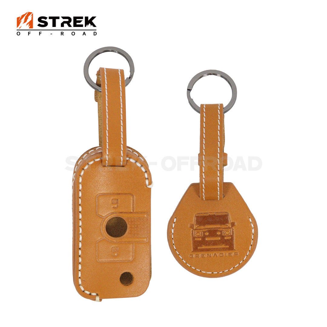 Two brown leather key fobs with metallic rings on a white background, featuring the 'STREK OFF-ROAD' brand.