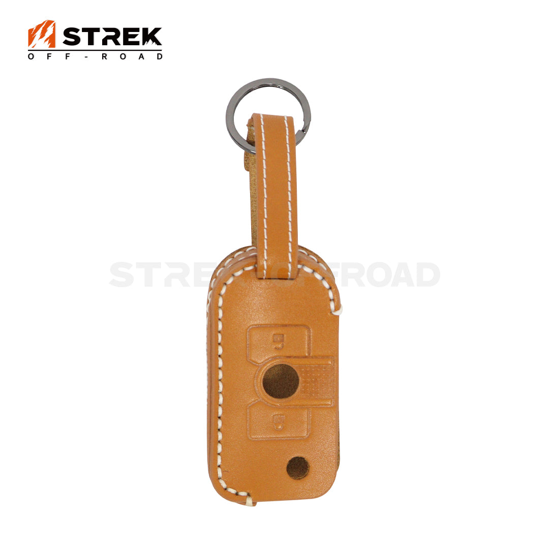 Brown leather key fob cover with 'STREK OFF-ROAD' branding on a white background