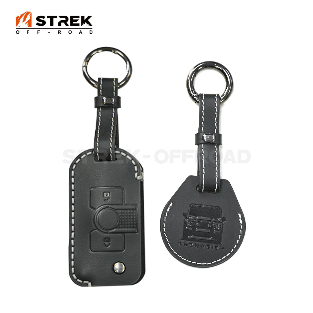 Two black leather keychains with embedded buttons on a white background, featuring the 'STREK OFF-ROAD' brand.