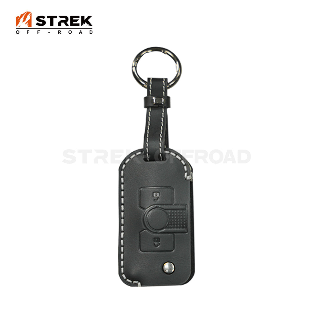 Black leather key fob cover with car key symbol on a white background, featuring the Strek Off-Road logo.