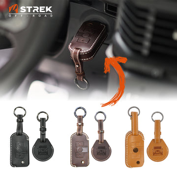 Collection of leather keychains with a car interior background, featuring the STREK Off-Road brand.