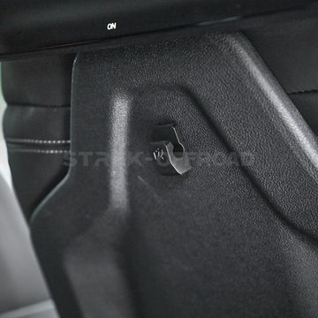 3D printed adhesive hook holding a phone cable inside a car