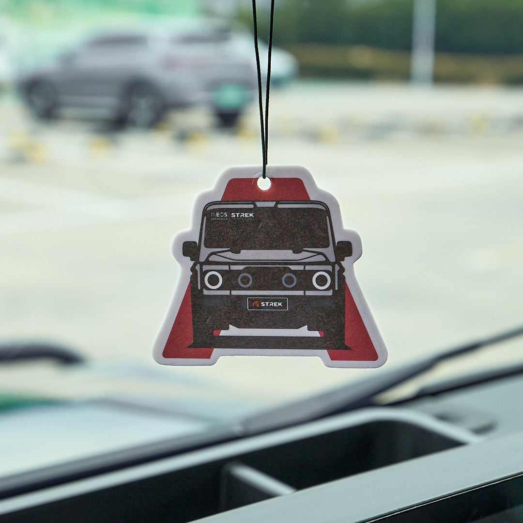 Grenadier Silhouette Air Freshener Card in Wild Bluebell scent hanging inside an INEOS Grenadier interior.