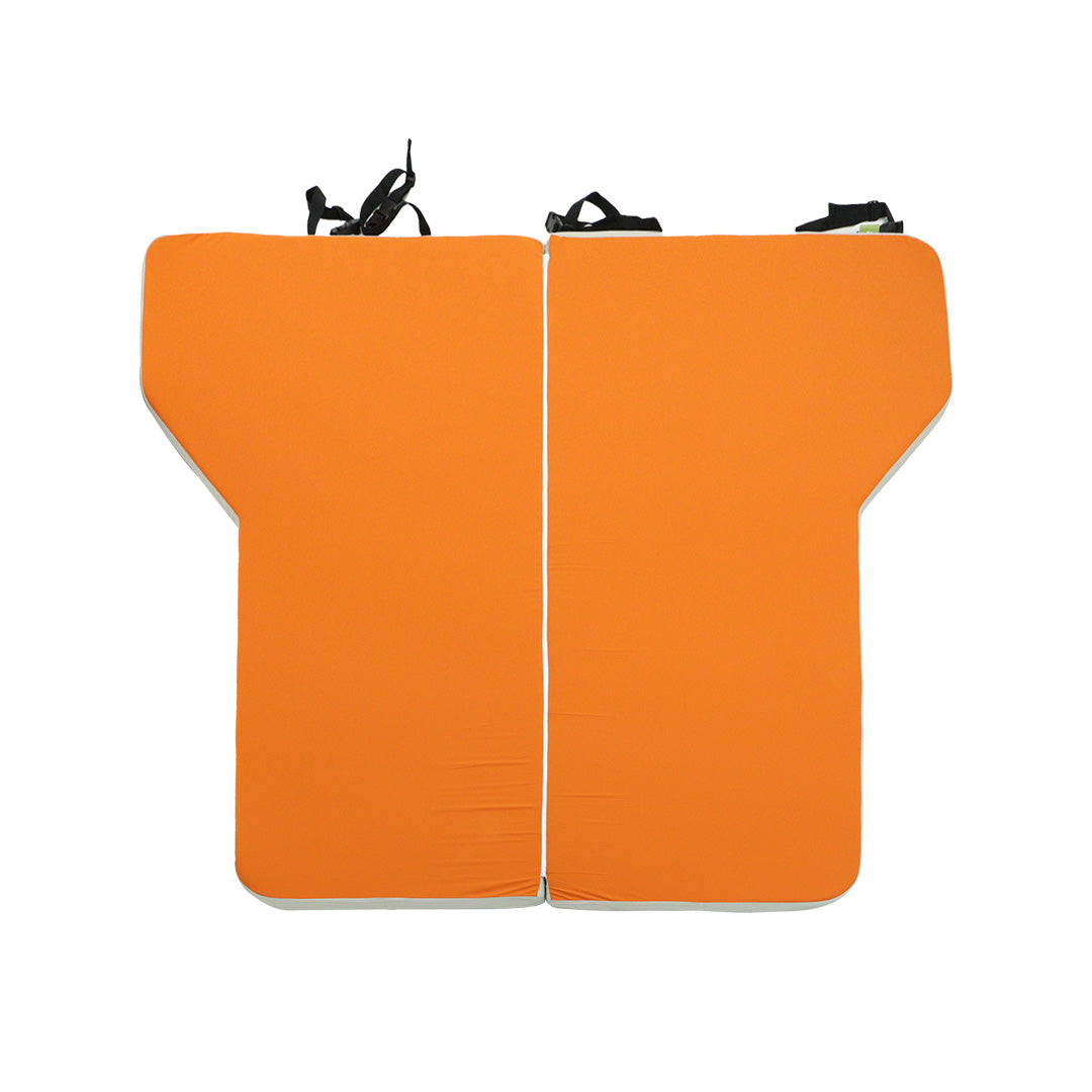 Top view of the orange INEOS Grenadier custom sleeping mattress showcasing wheel arch contour cutouts.