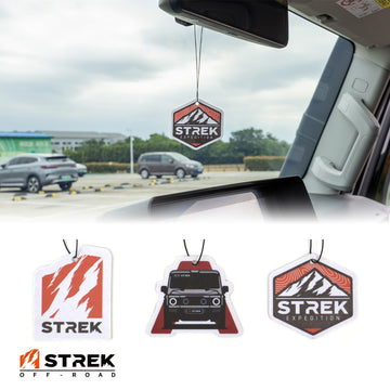 Branded overview graphic for INEOS Grenadier hanging air freshener cards with STREK Expedition Badge installed and Grenadier Silhouette, STREK Claw Logo, and STREK Expedition Badge designs displayed below.