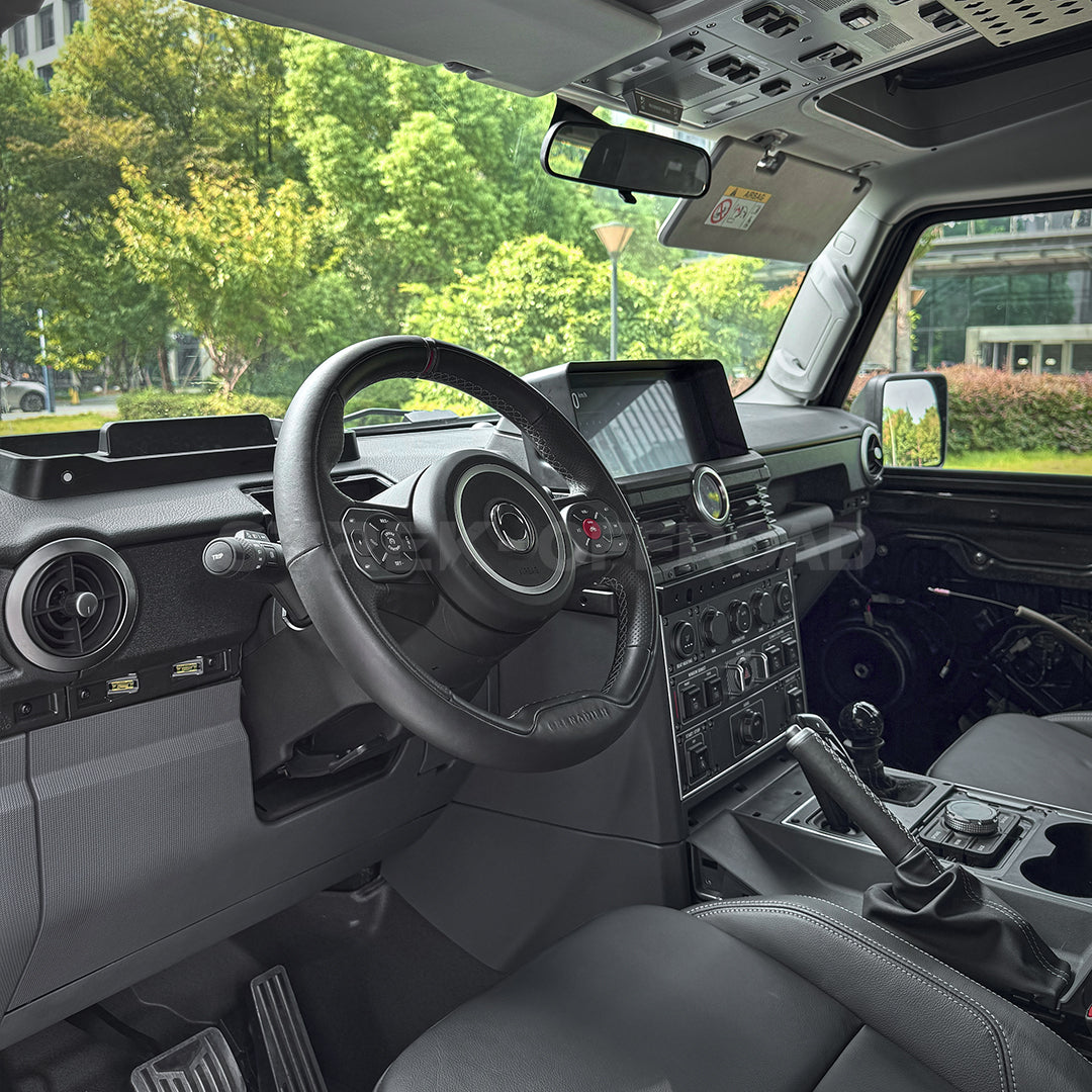 Matte black anti-glare cover installed on Ineos Grenadier dashboard using 3M adhesive
