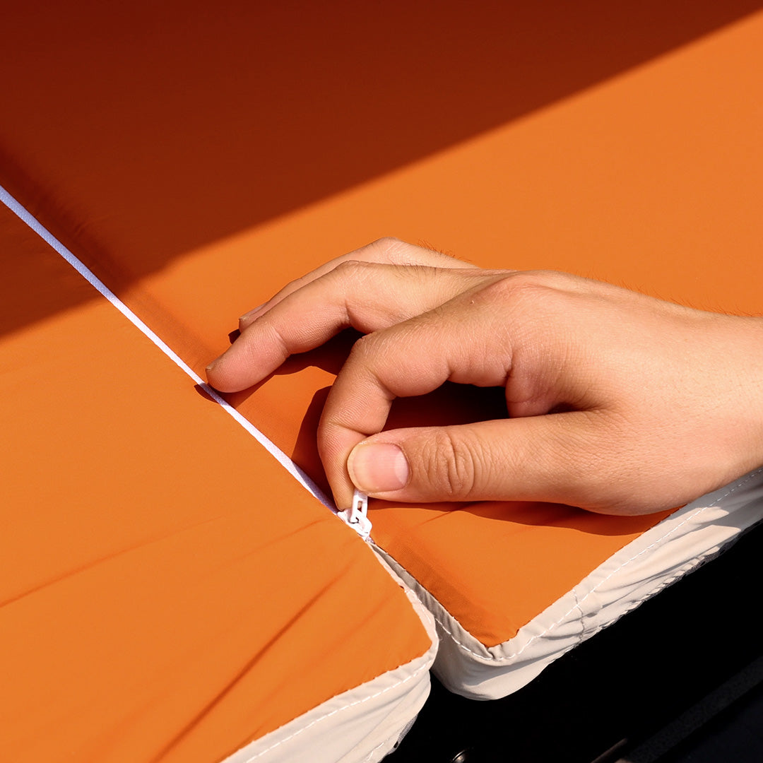 Close-up view of the center zipper connecting the two split pads of the INEOS Grenadier sleeping mattress by STREK OFF ROAD.