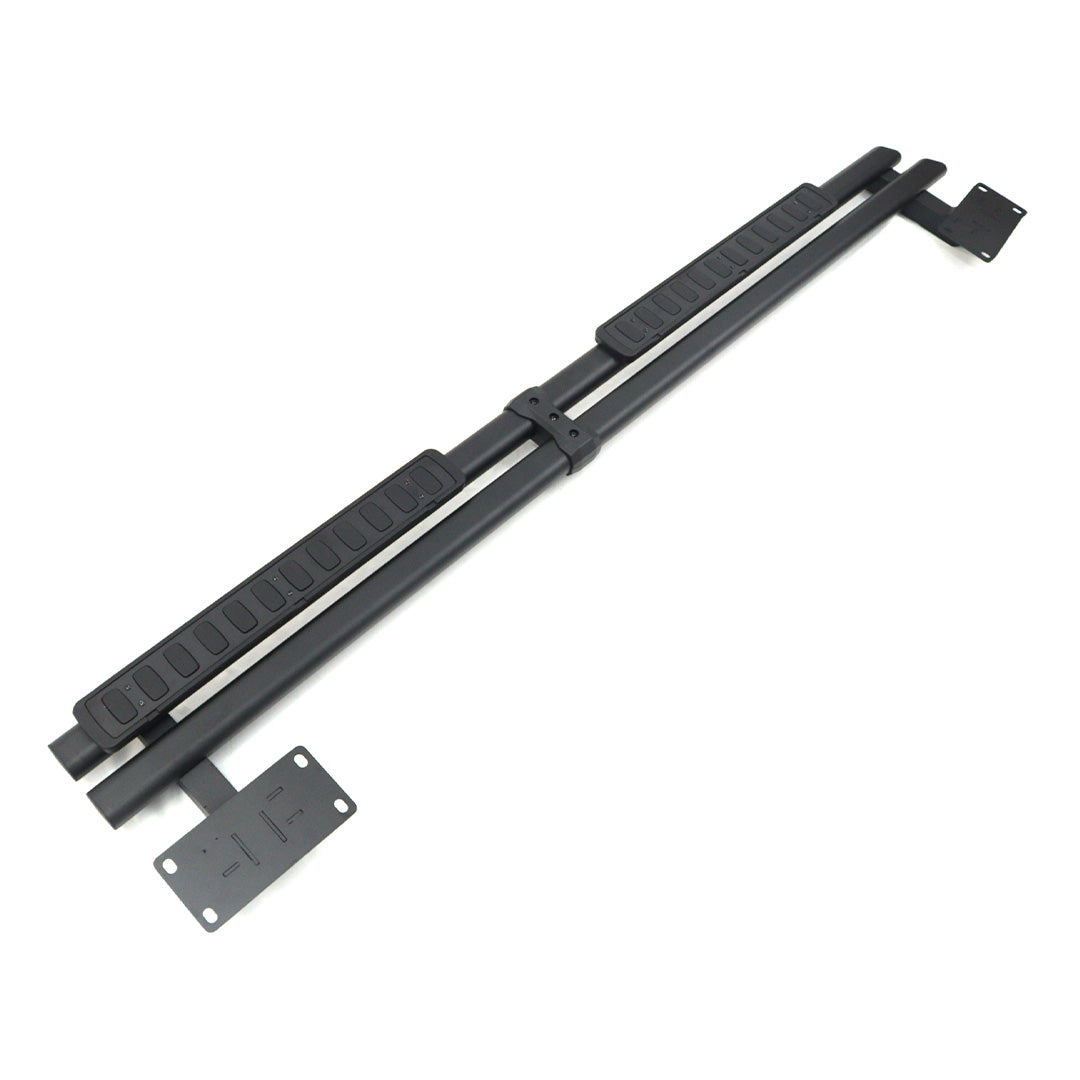 Angled view of a black fixed aluminum running board showing dual tube profile, textured step pads, center clamp, and mounting brackets for INEOS Grenadier Quartermaster.