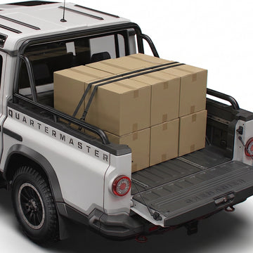 Retractable ratchet straps securing cargo boxes in the Ineos Grenadier Quartermaster pickup bed