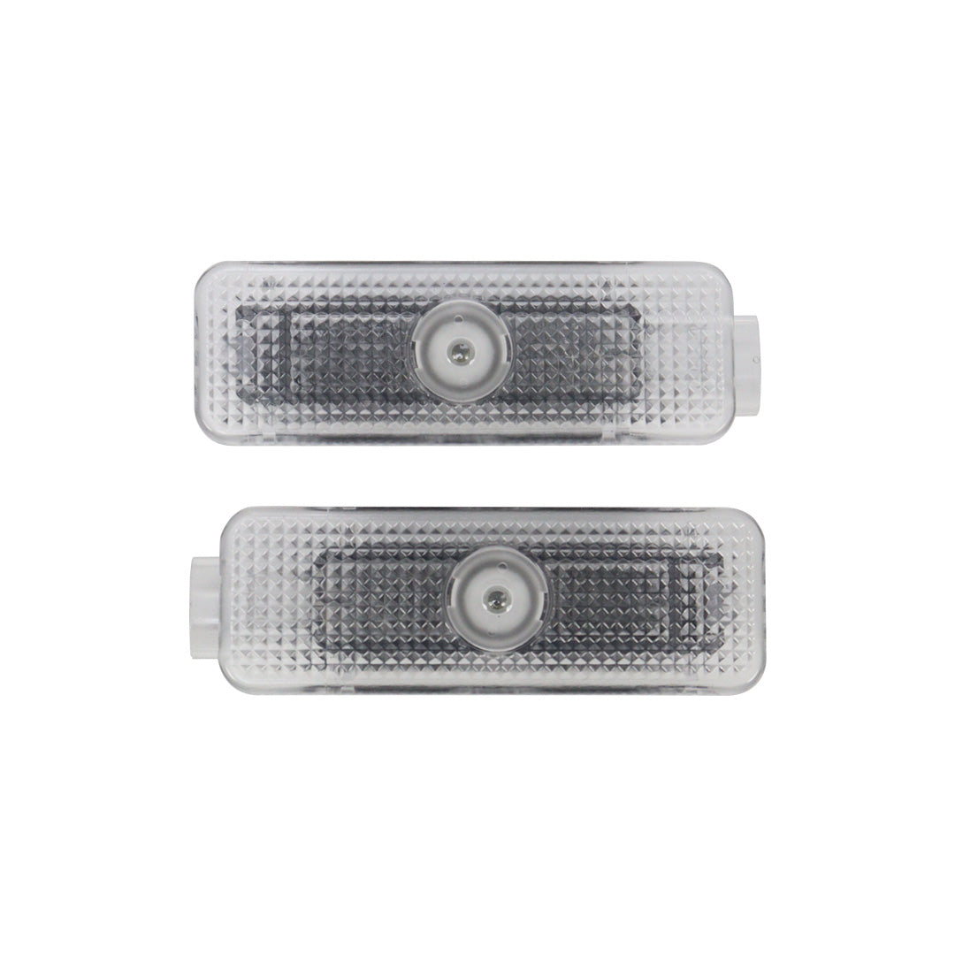 Pair of direct-fit LED puddle lamp replacement modules showing front optical projector lenses on a white background.