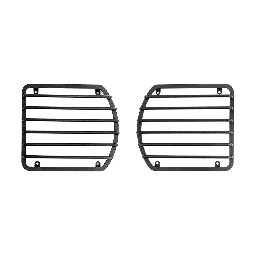 STREK Off Road black metal front headlight guards compatible with INEOS Grenadier, heavy-duty steel protective mesh grilles on a white background.