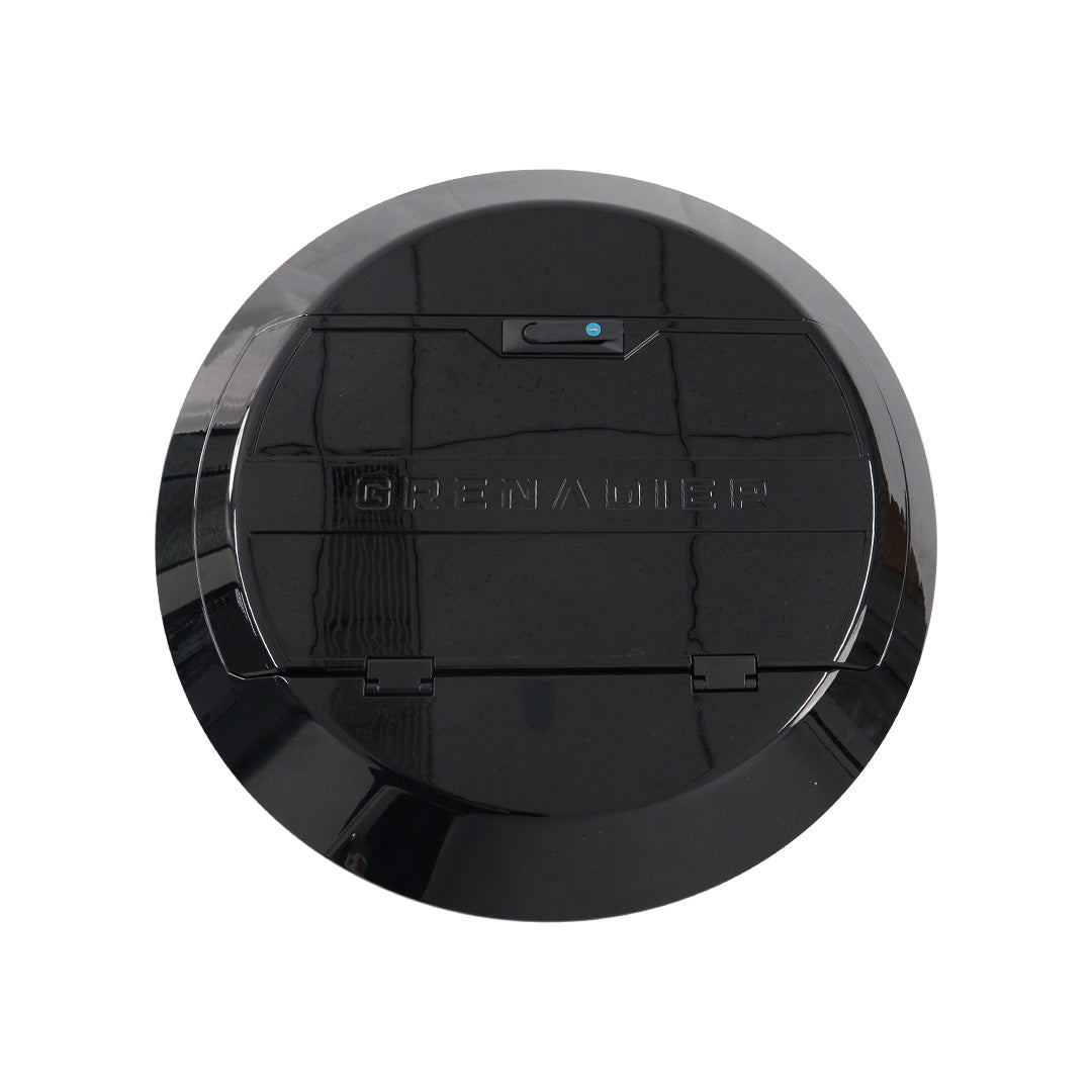 STREK Off Road spare tire cover component of the integration kit designed for INEOS Grenadier, matte black texturized finish on a white background.
