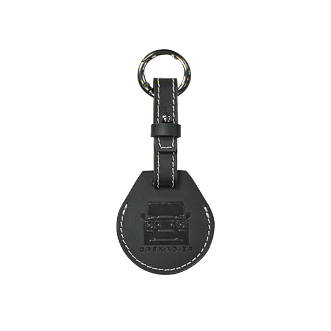 Black leather AirTag case attachment accessory with a durable silver circular key ring compatible with INEOS Grenadier smart tracking key setups.