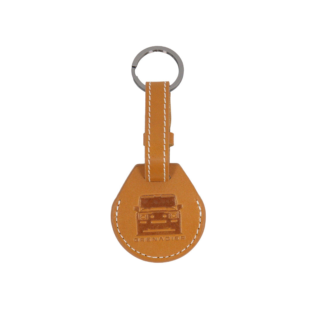 Orange leather AirTag protective cover with heavy-duty metal split ring featuring a debossed off-road vehicle silhouette compatible with INEOS Grenadier gear.