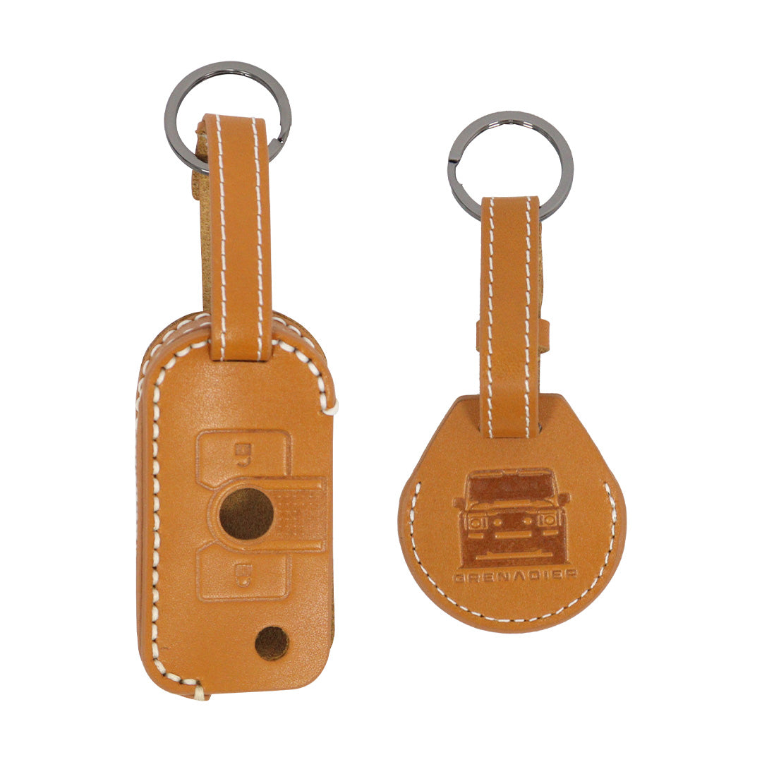 STREK Off Road high-visibility orange leather remote key jacket and AirTag protector set compatible with INEOS Grenadier utility key.