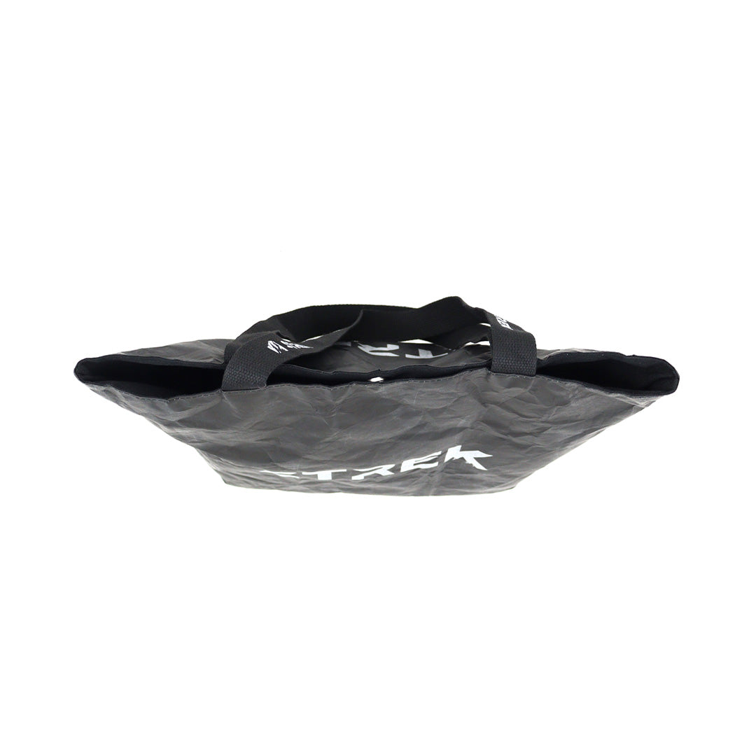 Top side profile of the STREK Overland Tyvek Utility Tote Bag showing the wide opening, soft structure, and stitched carry handles.