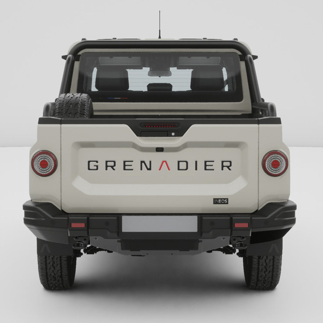 Straight rear view of a white INEOS Grenadier Quartermaster with GRENADIER tailgate inlay decals installed.